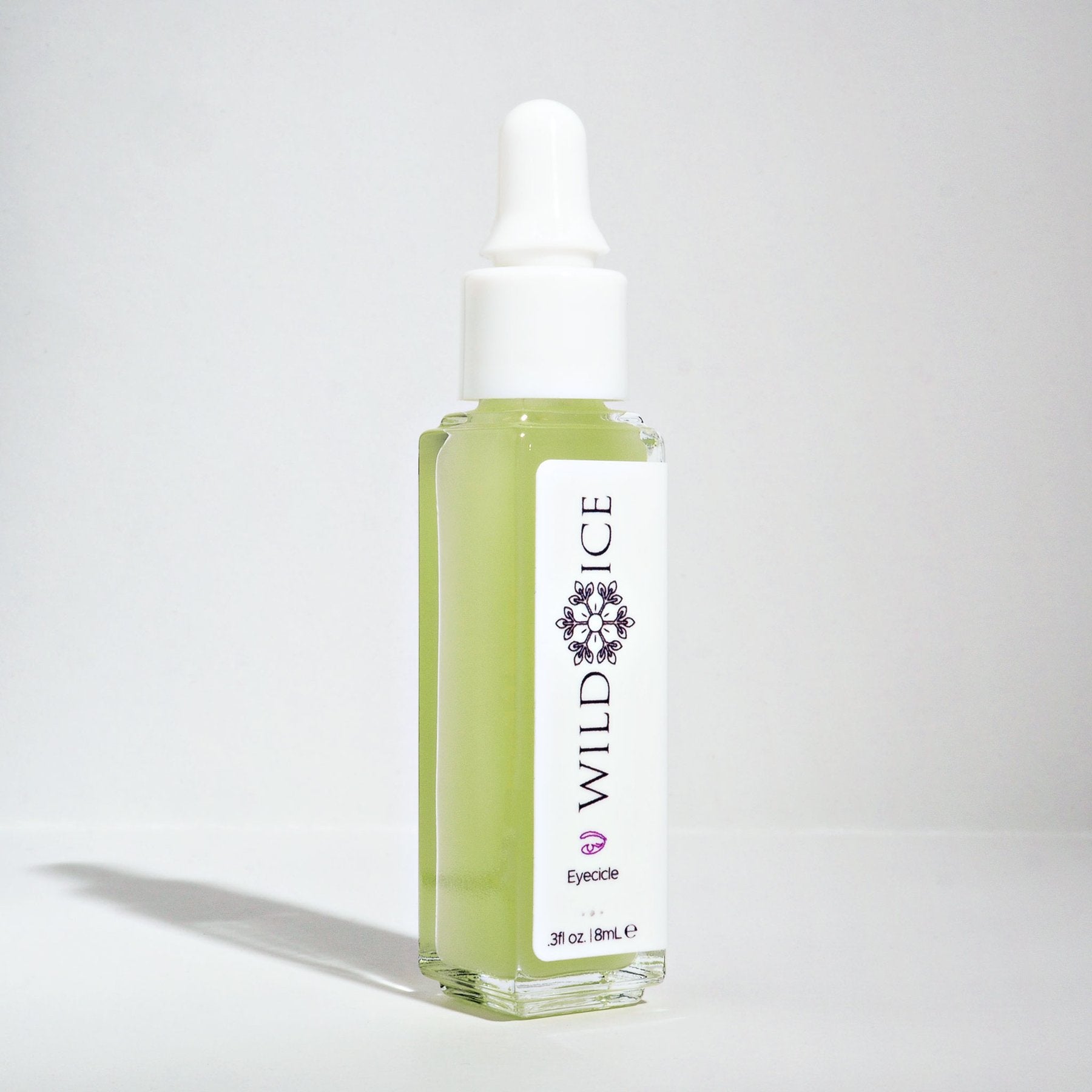 A dropper bottle of Eyecicle peptide eye serum standing upright against a plain pale studio background