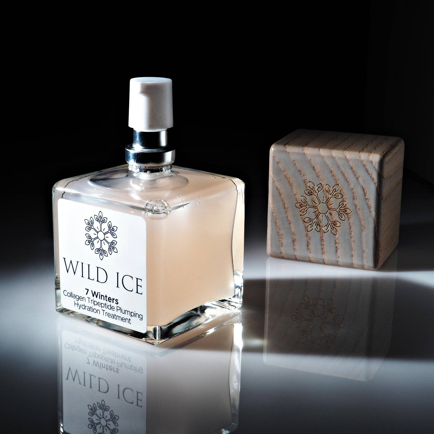 A bottle of 7 Winters collagen tripeptide serum with its wood cap set beside it, lit against a dark studio background