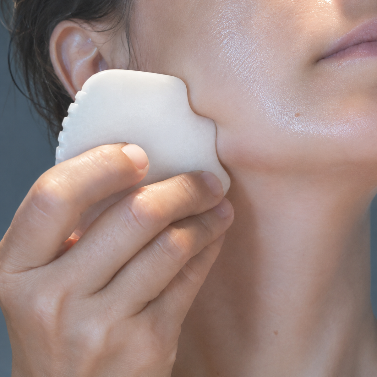 Mammoth's Tooth: Gua Sha for Deeper Absorption & Lymphatic Drainage, cold-preserved skincare by Wild Ice Botanicals, in use