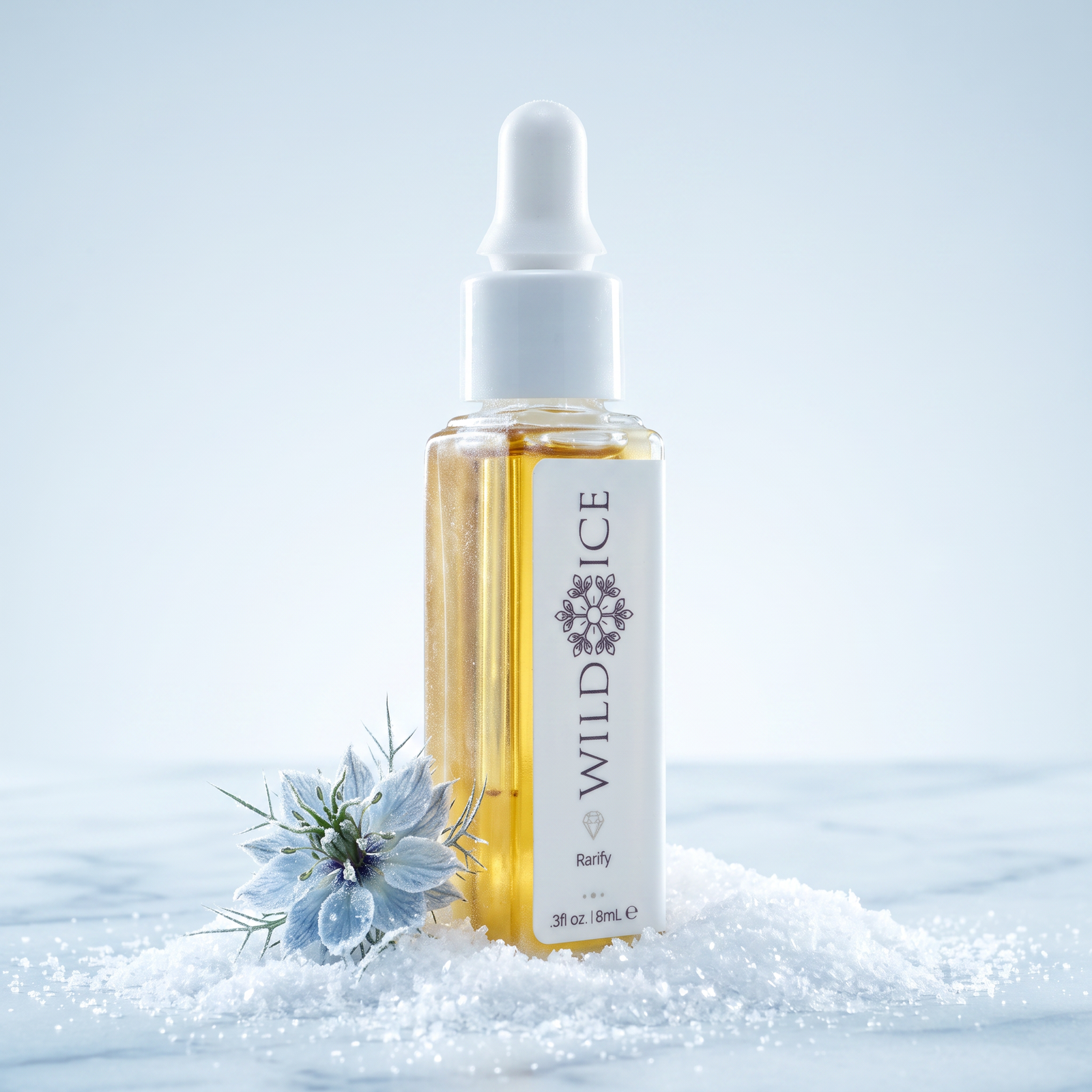 Rarify golden botanical oil in its dropper bottle, standing in snow beside a frosted nigella bloom