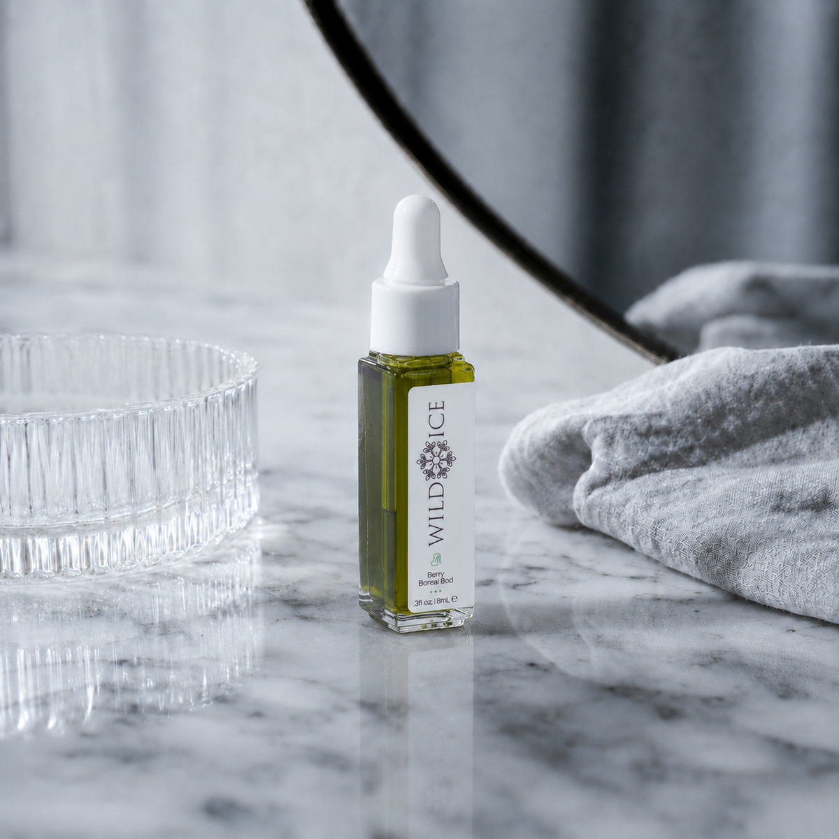 Mini Berry Boreal Bod: Blue Tansy & Elderberry Body Oil, cold-preserved skincare by Wild Ice Botanicals, on a vanity