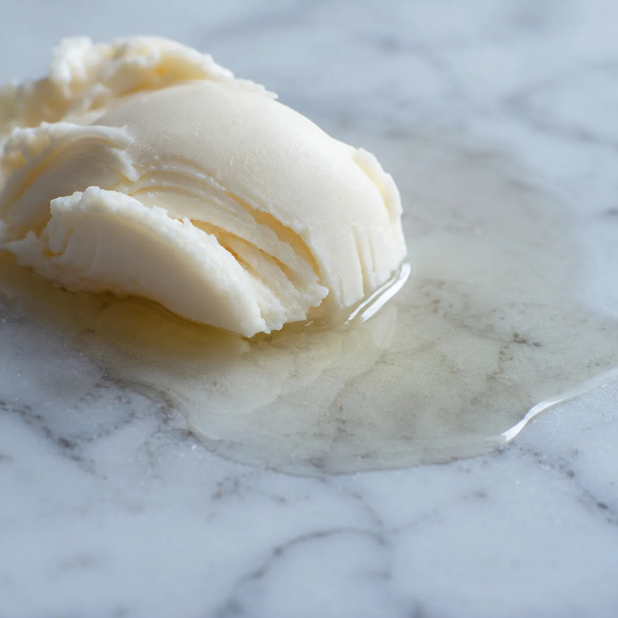 Shea butter melting into jojoba and coconut oil