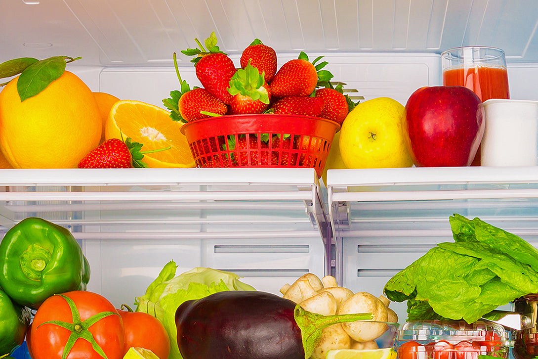 A refrigerator shelf packed with fresh fruit and vegetables