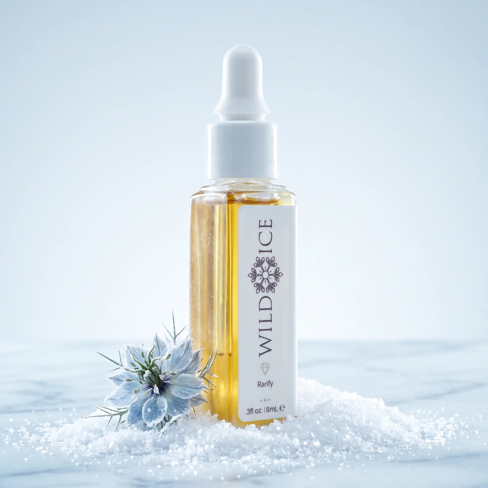 Rarify golden botanical oil in its dropper bottle, standing in snow beside a frosted nigella bloom